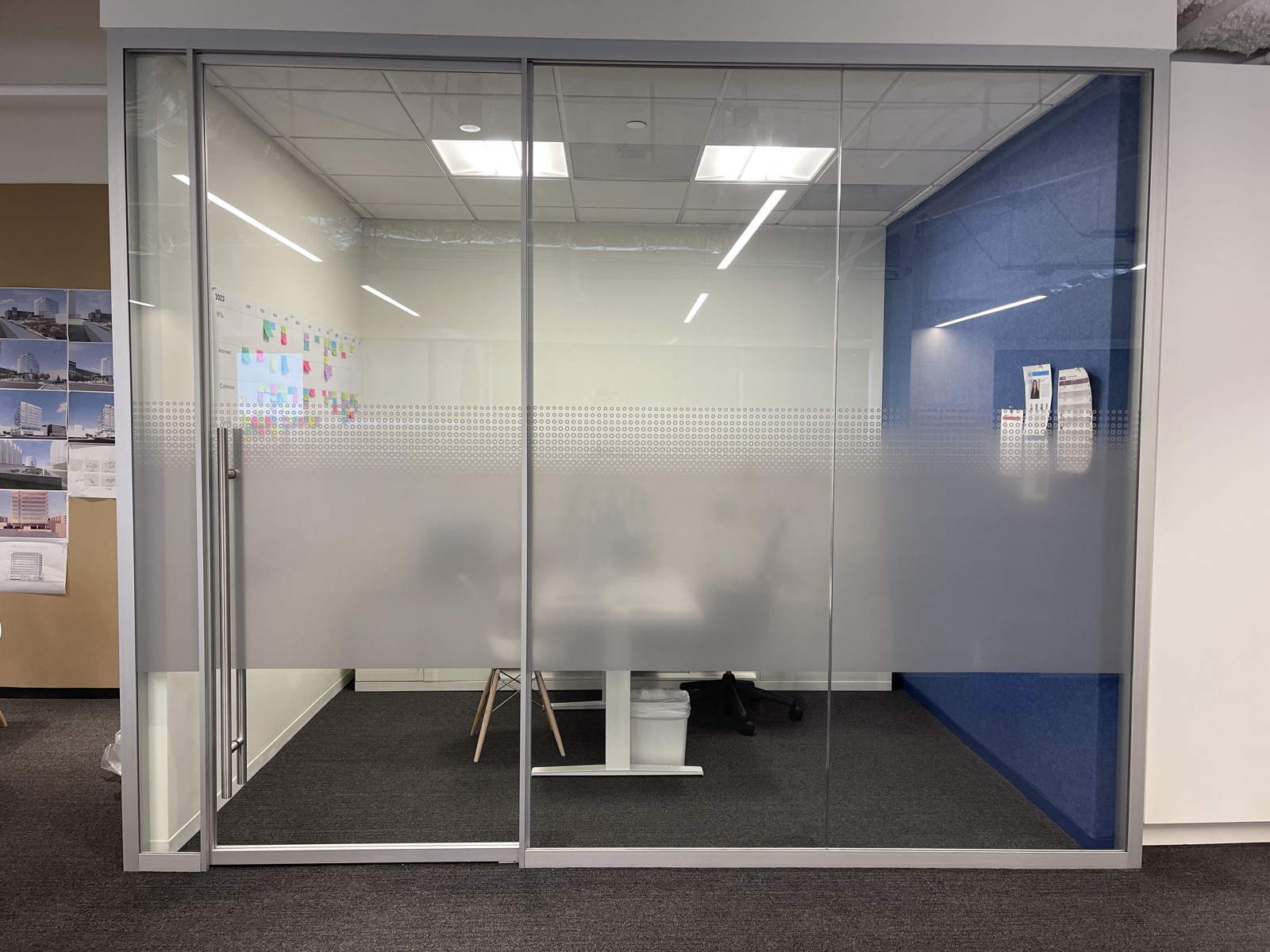 Office pod with frosted privacy film and grid pattern