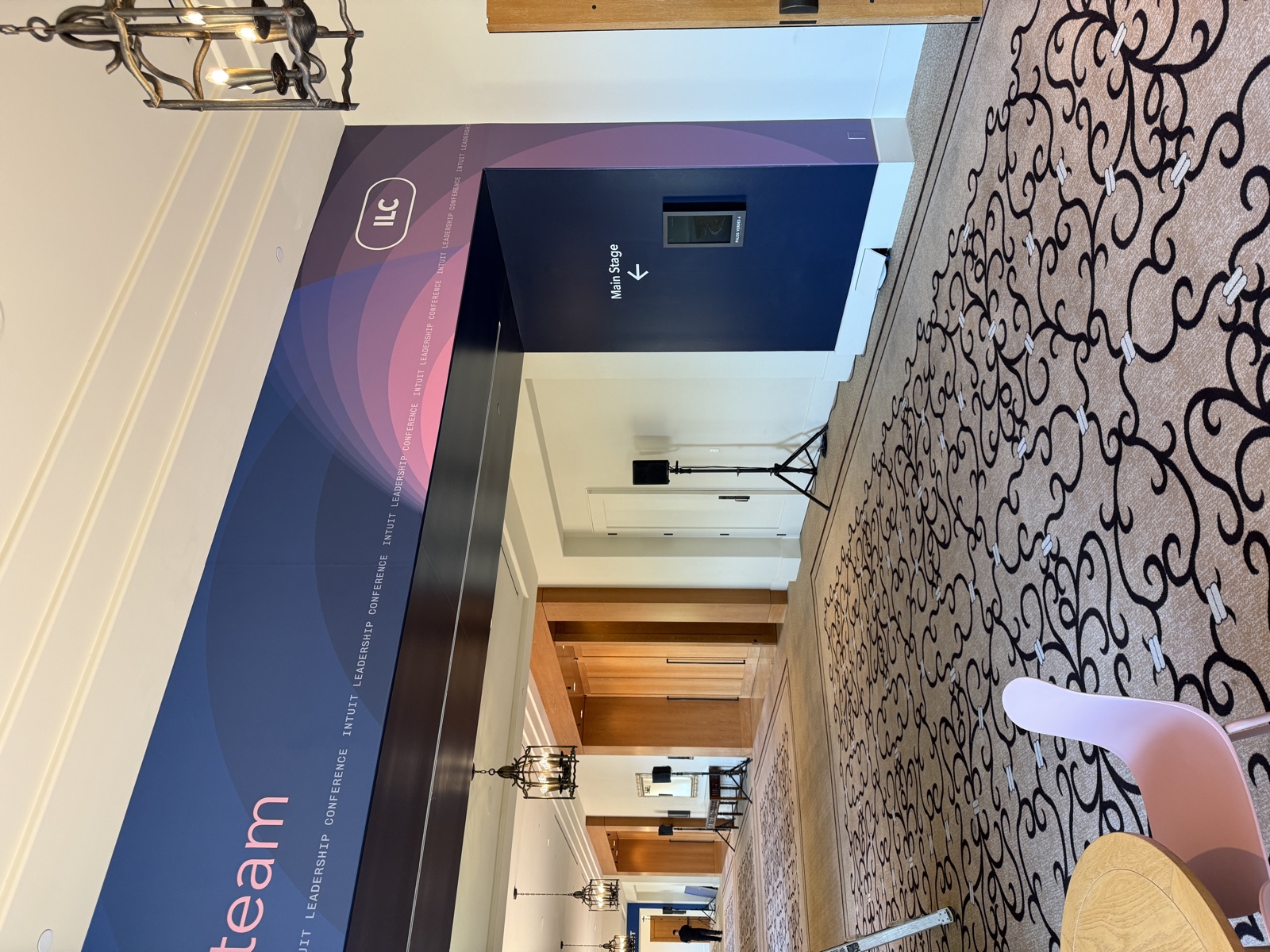 ILC branded directional signage and overhead banner in hotel hallway