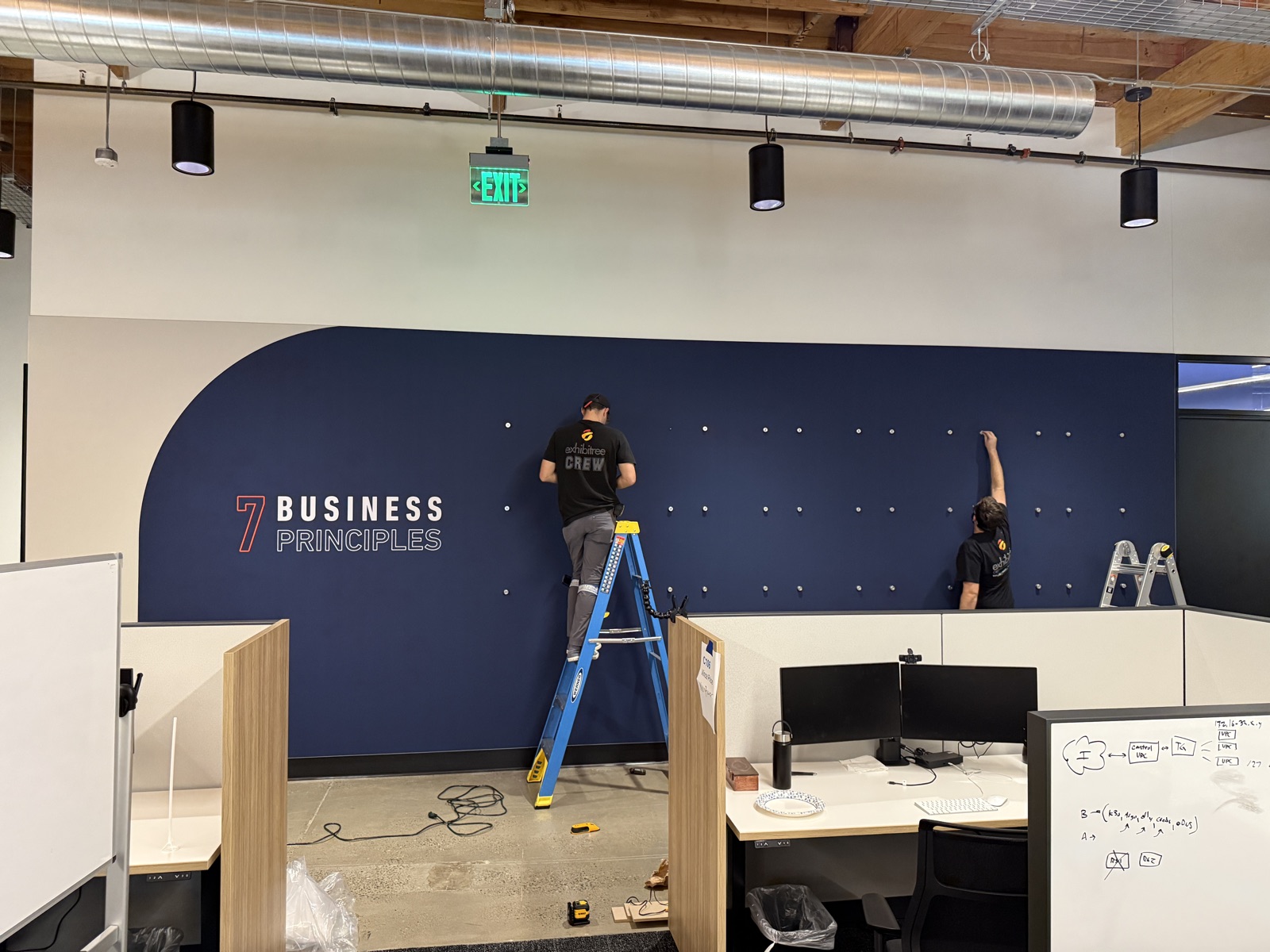 7 Business Principles branded wall with pegboard detail
