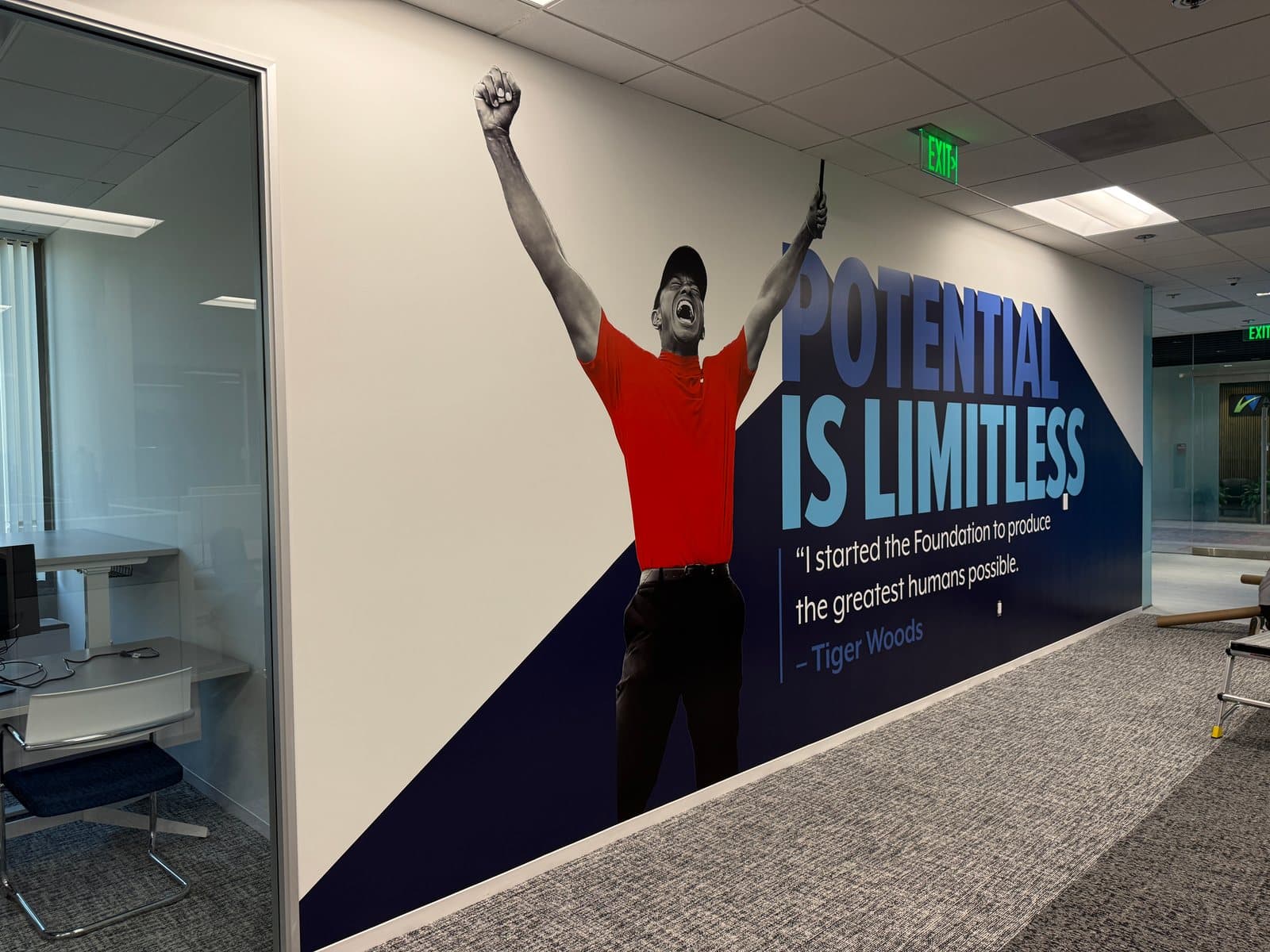 Potential Is Limitless wall graphic with a photo of Tiger Woods and his words on starting the Foundation