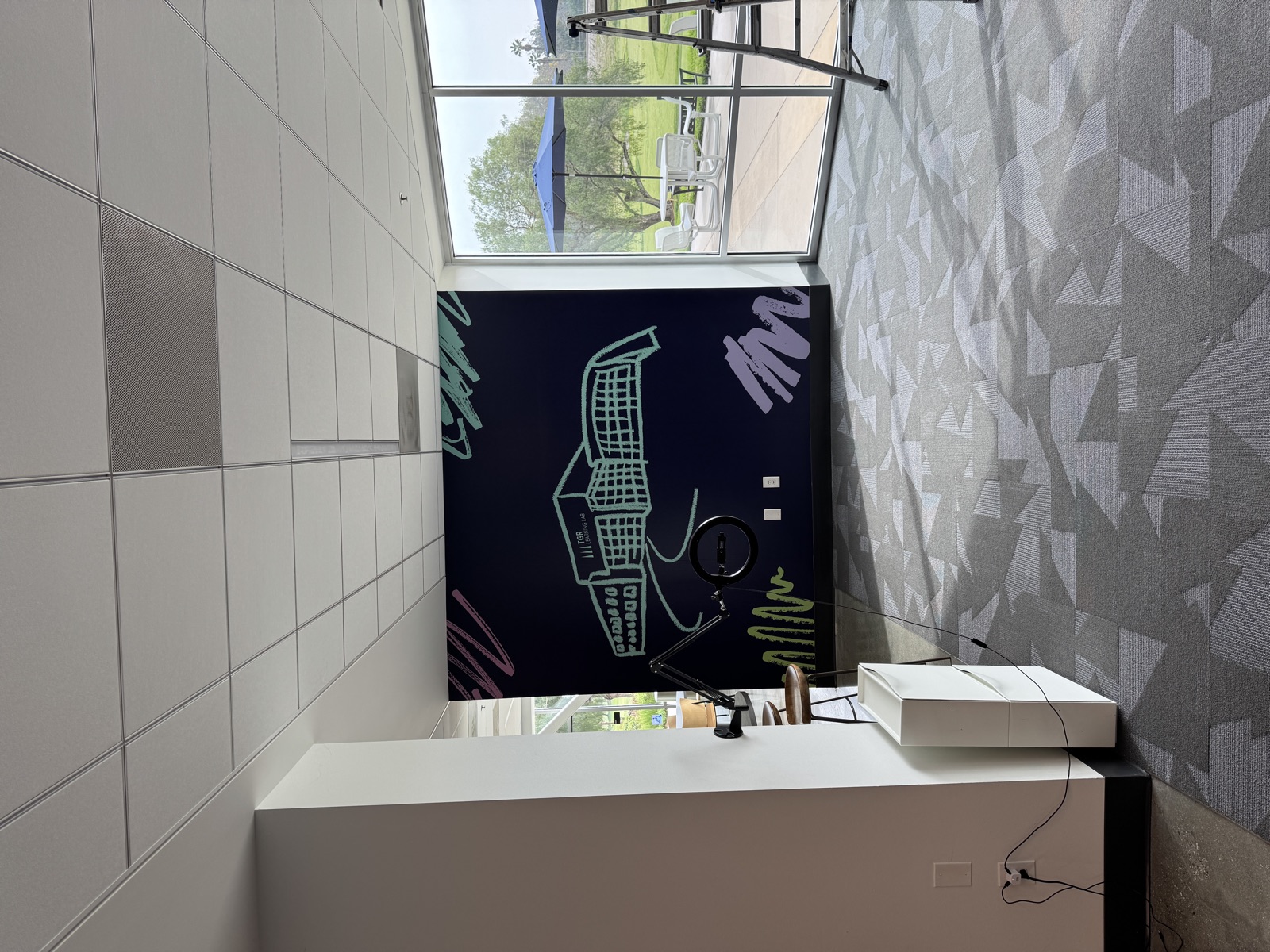 Dark accent wall with neon-style city illustration and geometric patterns
